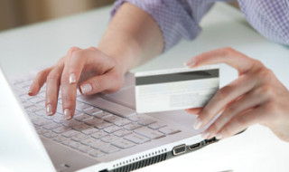 woman making a purchase online with her credit card