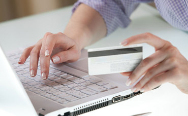 woman making a purchase online with her credit card