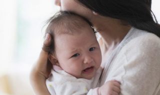 asian-mother-comforting-crying-baby