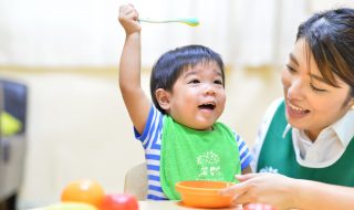 infant with a teacher at mealtime