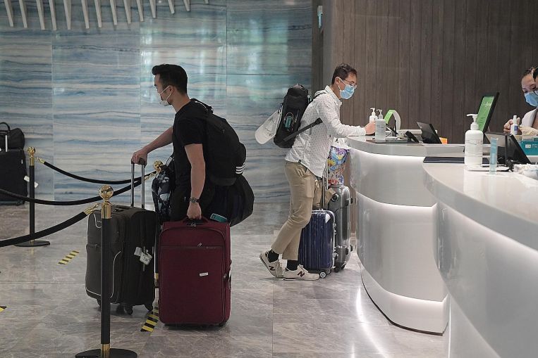 travellers checking-in at a hotel amid COVID-19