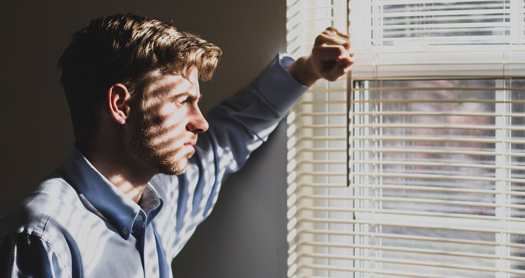 Man-Staring-Out-The-Window