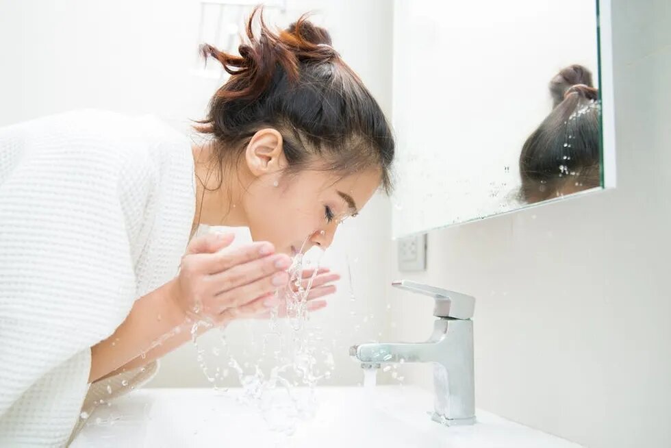asian woman washing face