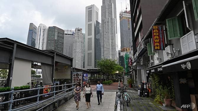 office-workers-wearing-face-masks-are-seen-in-the-financial-business-district-in-singapore