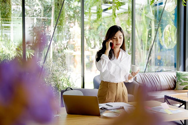 portrait-of-confident-young-asian-woman-calling-by-mobile-phone