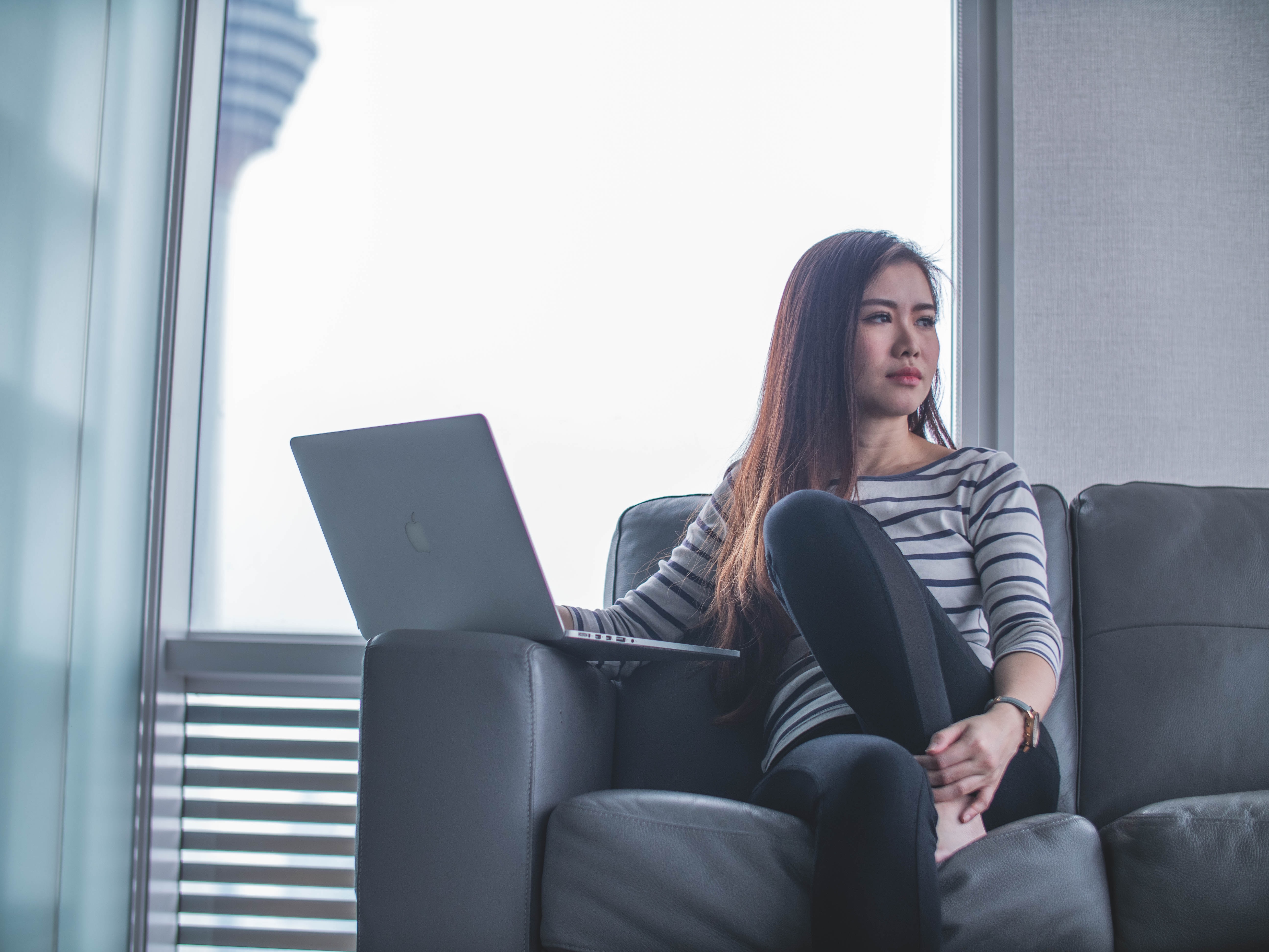 woman sitting on a couch thinking about something