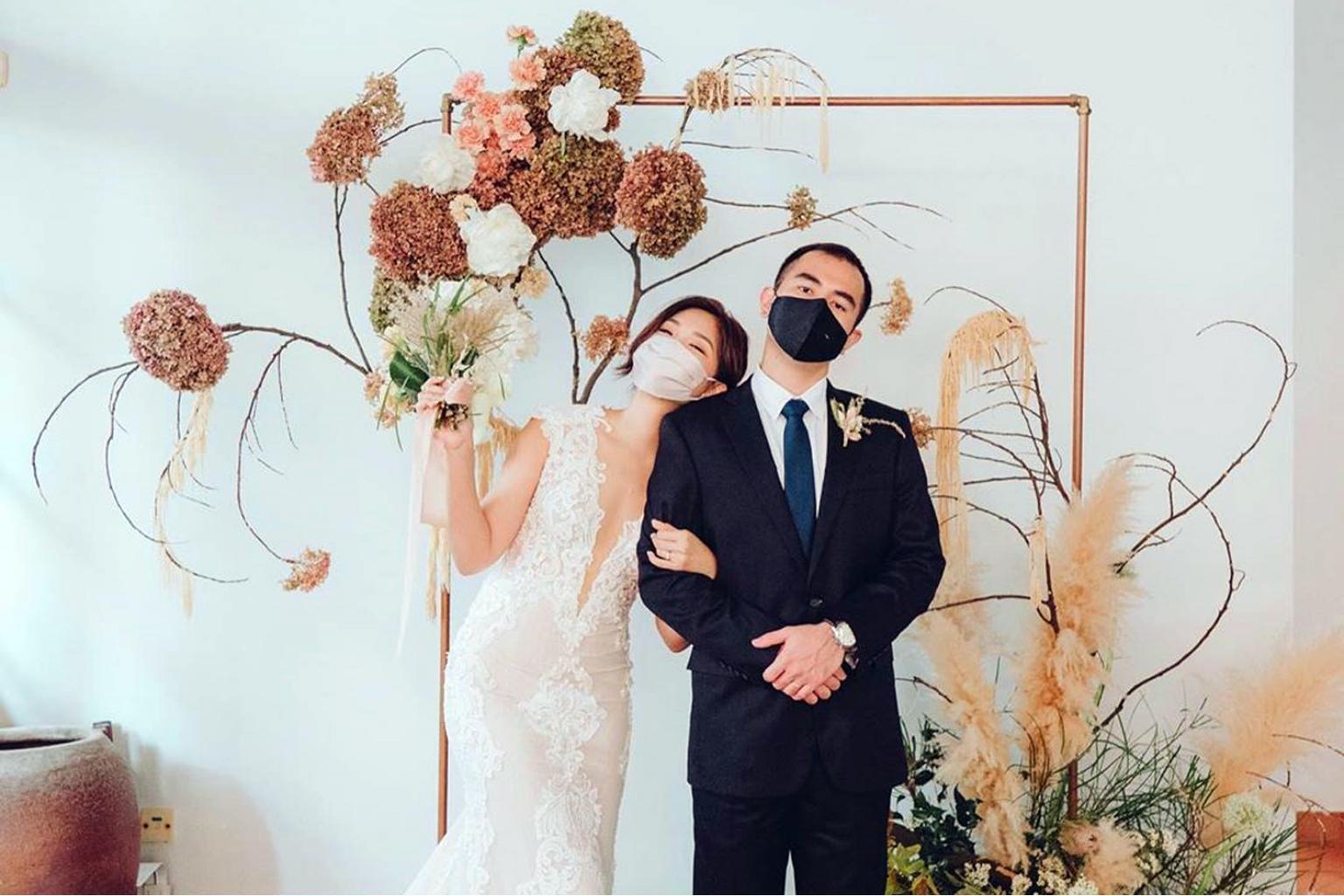 a couple wearing masks for a wedding photo