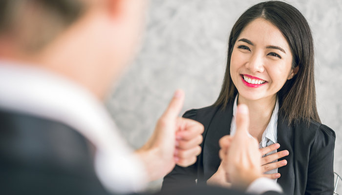 a man giving a thumbs up to a lady at work