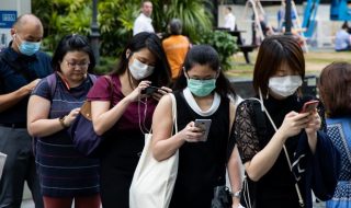 a queue of people using their phones