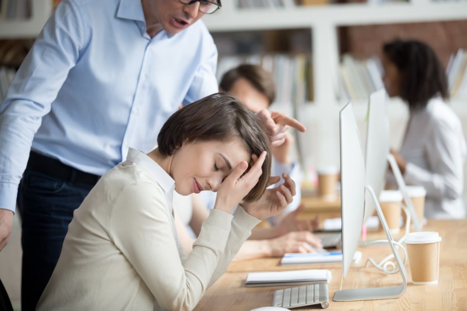 a woman getting scolded by a coworker