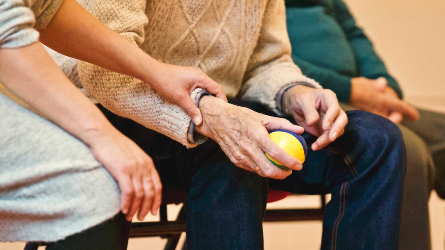 a woman holding an elderly's hand