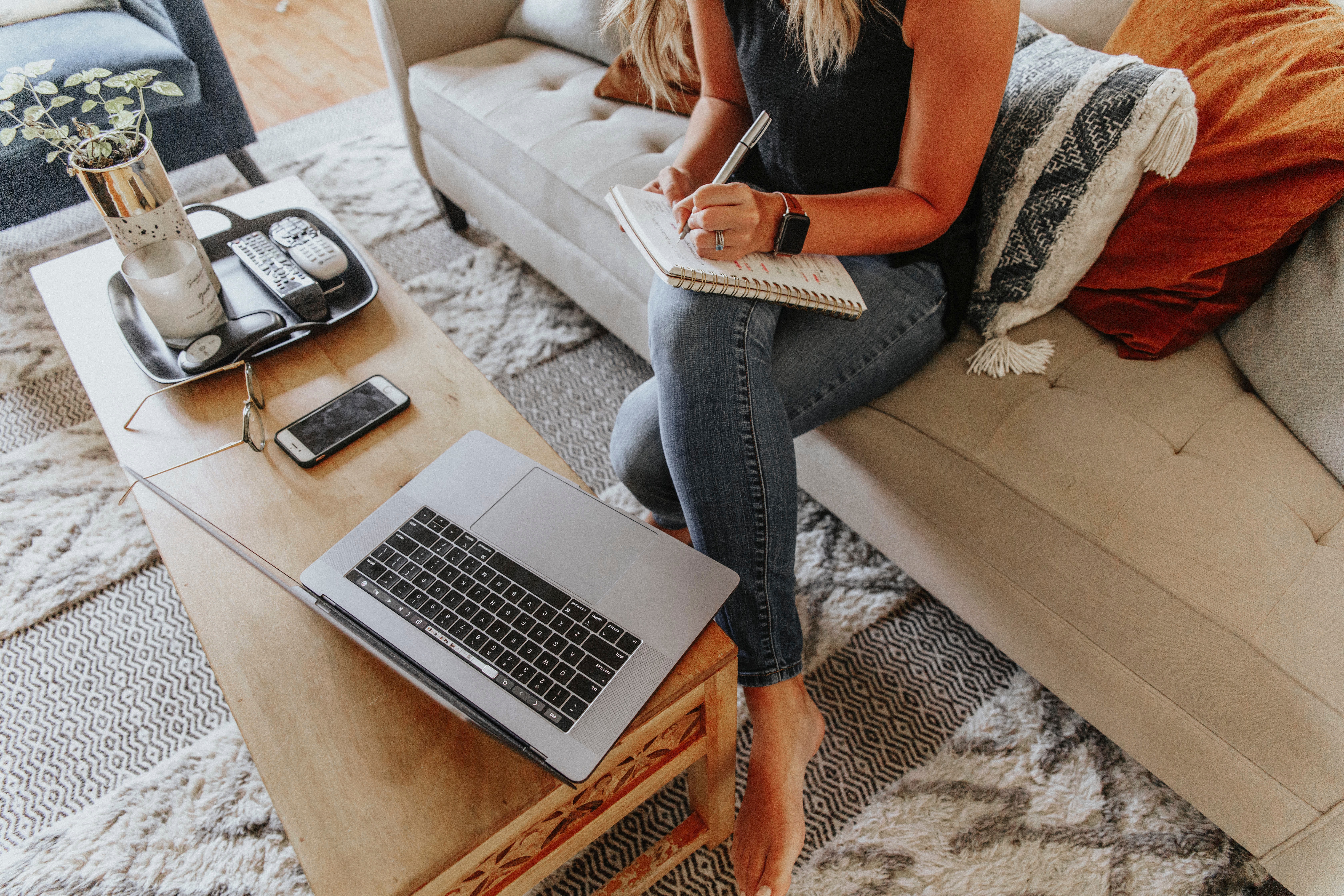 a women writing down something on her notebook