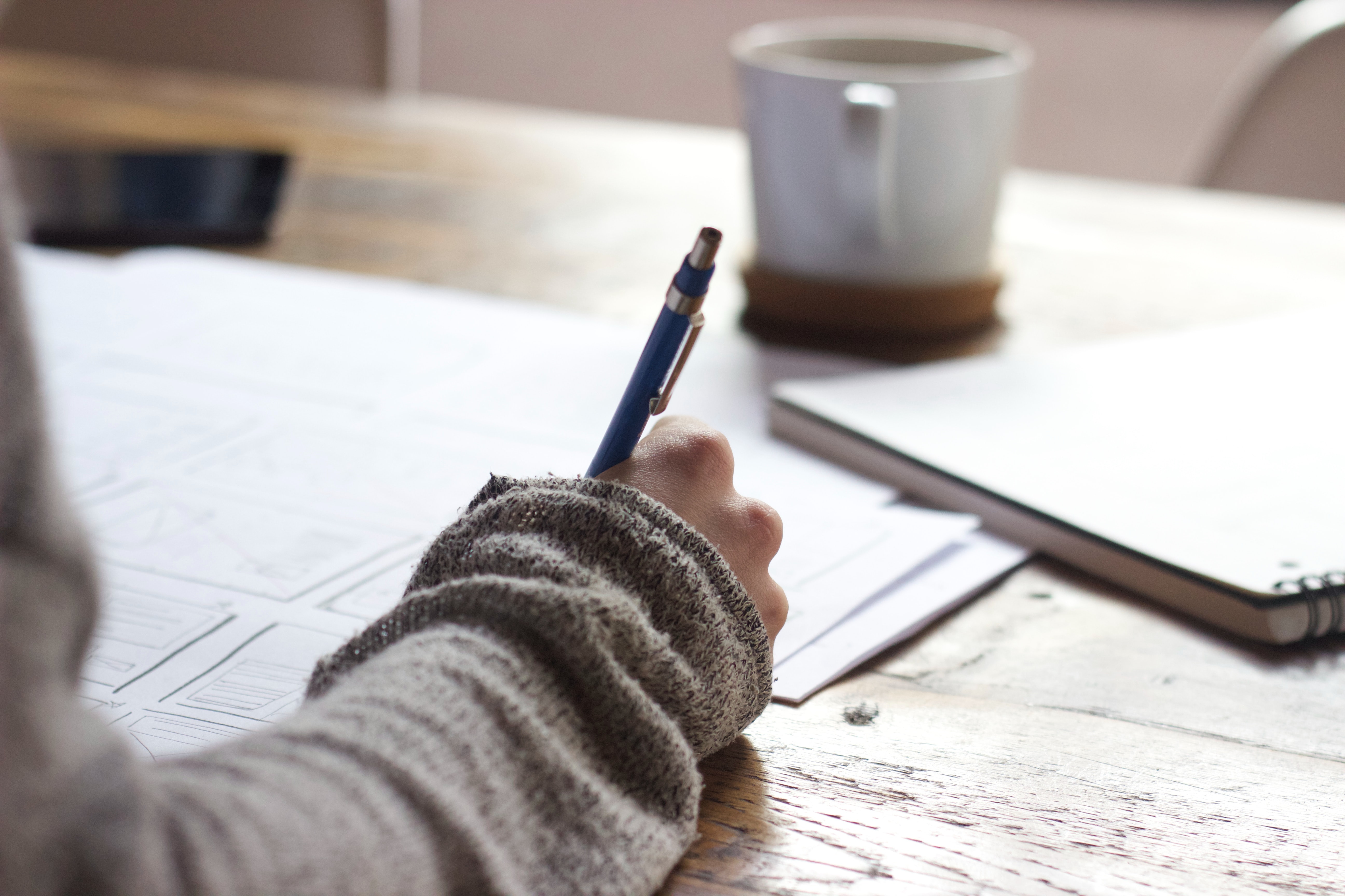 a lady writing something with a pen