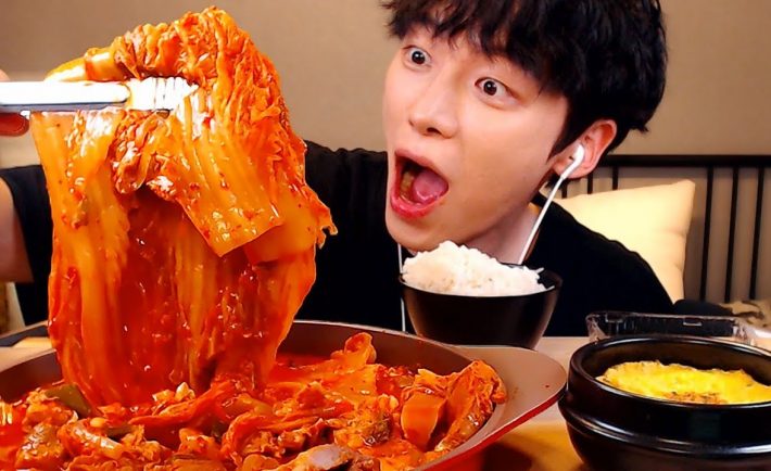 korean holding a kimchi cabbage