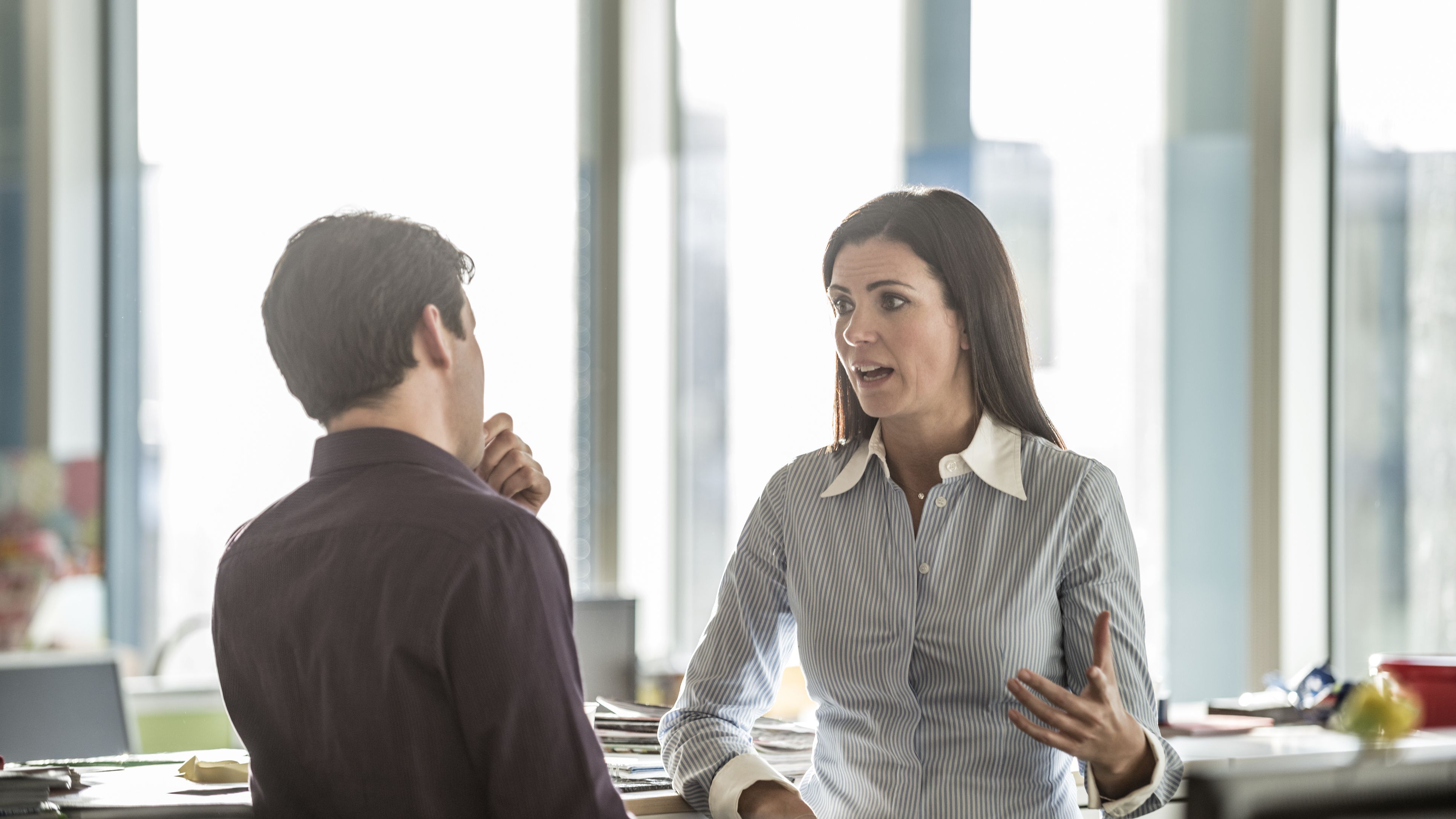 two-business-people-having-serious-discussion-in-the-office