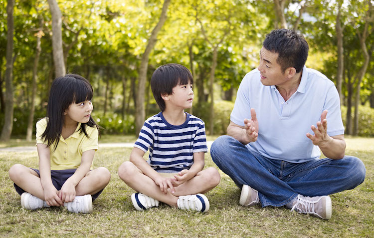 a father talking to his two kids