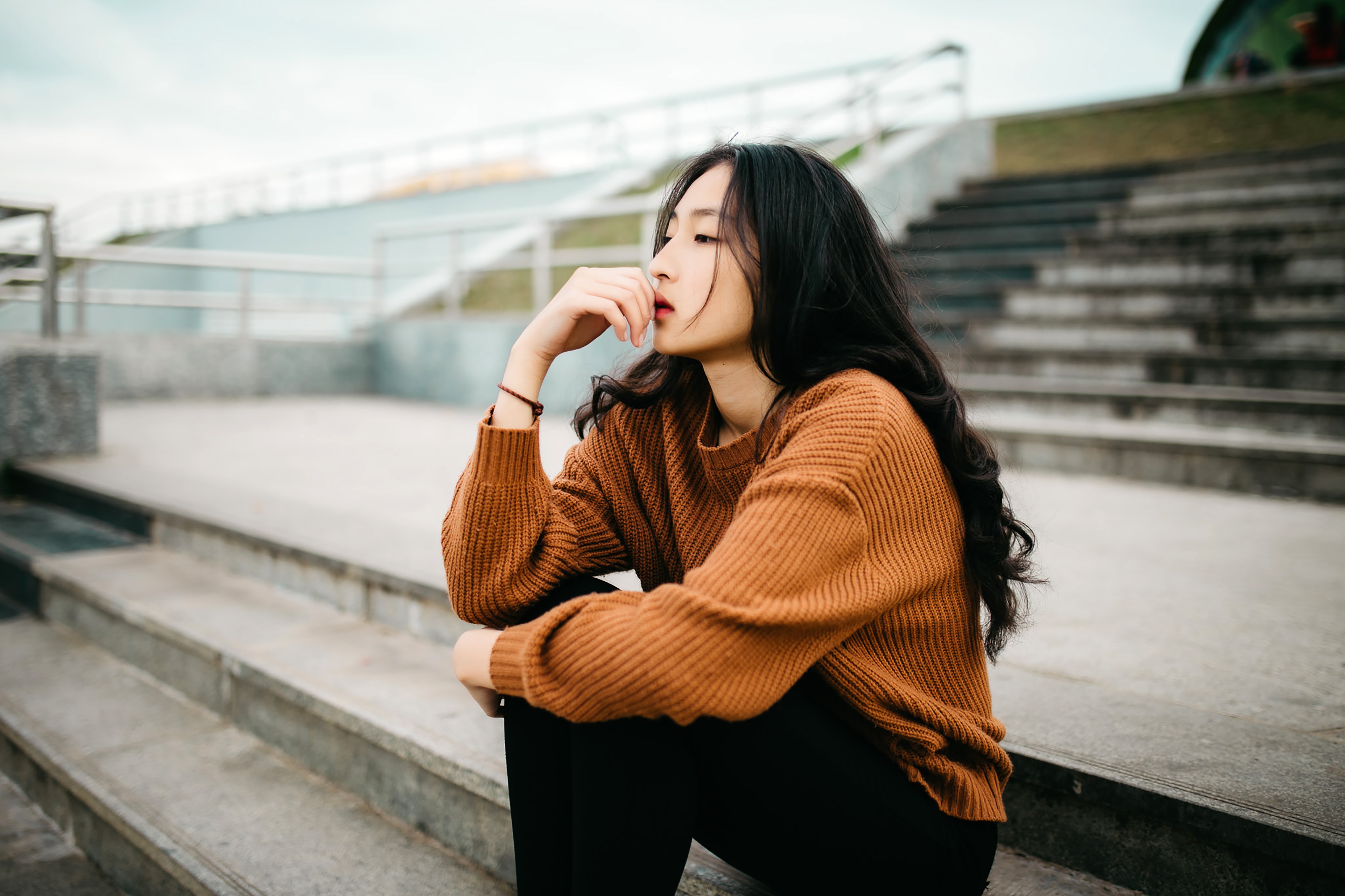 an Asian woman thinking about something