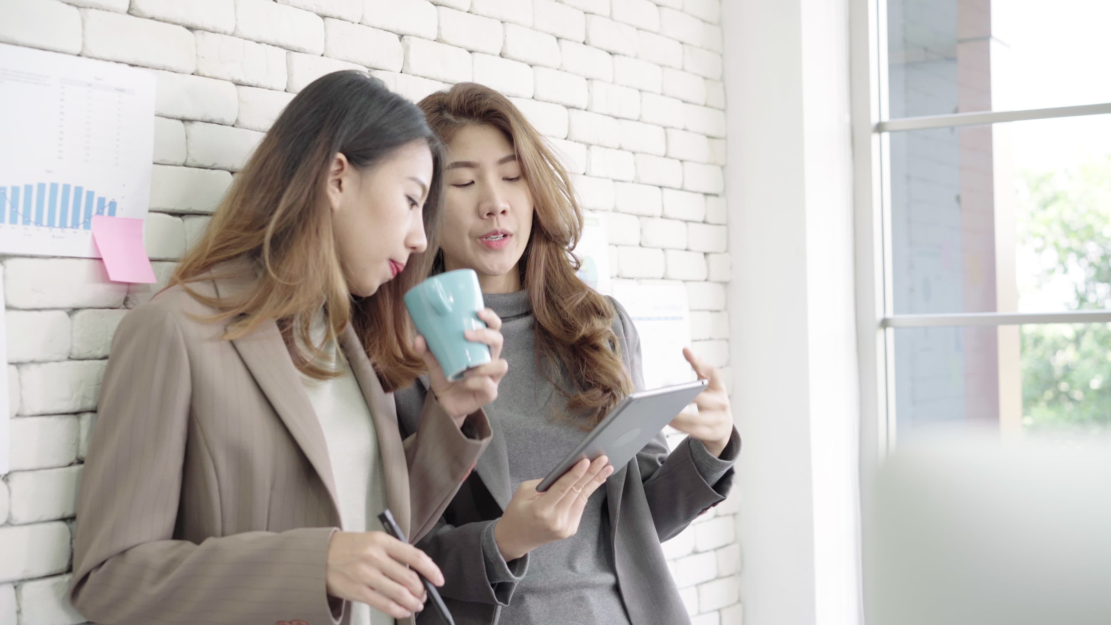 two asian woman talking