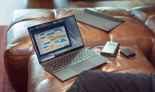 a grey laptop on a sofa