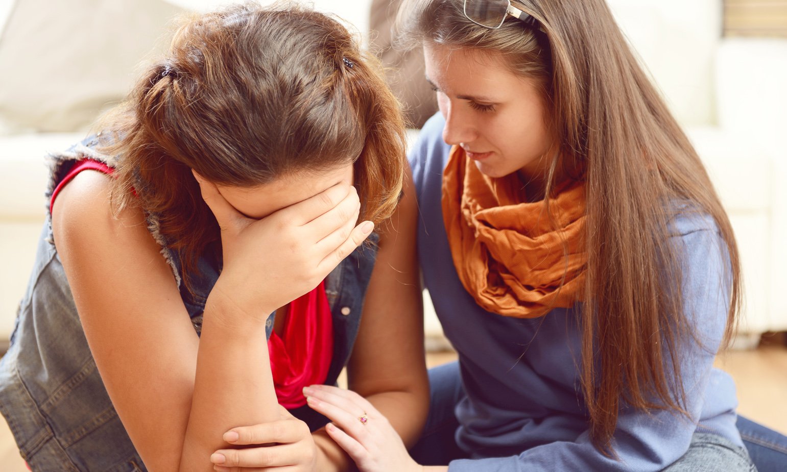 a woman comforting another woman