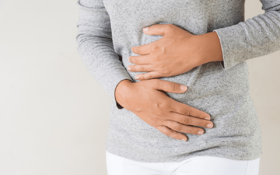 a woman holding on to her stomach