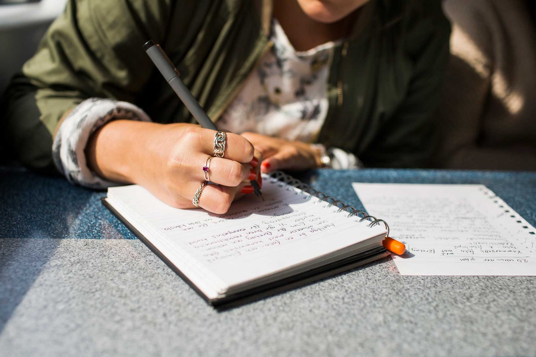 a woman writing on her journal