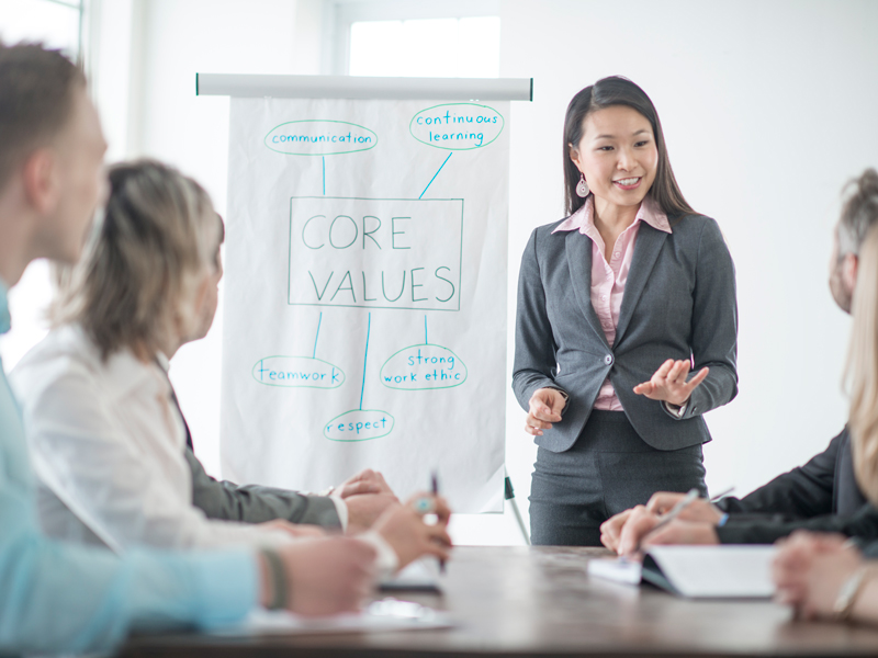 an asian woman leading a meeting