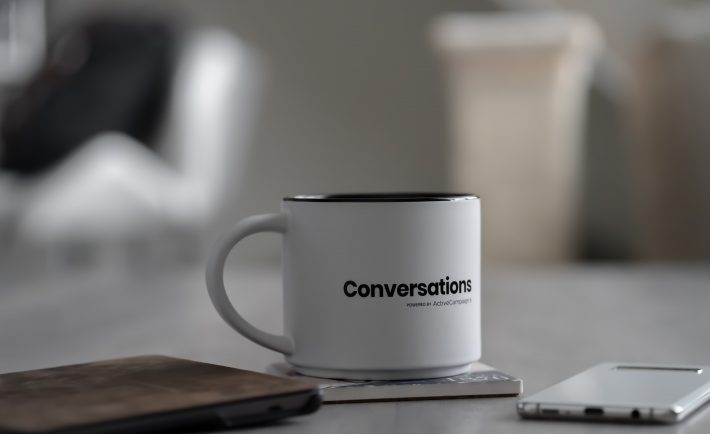 a white mug with the word 'conversations' printed