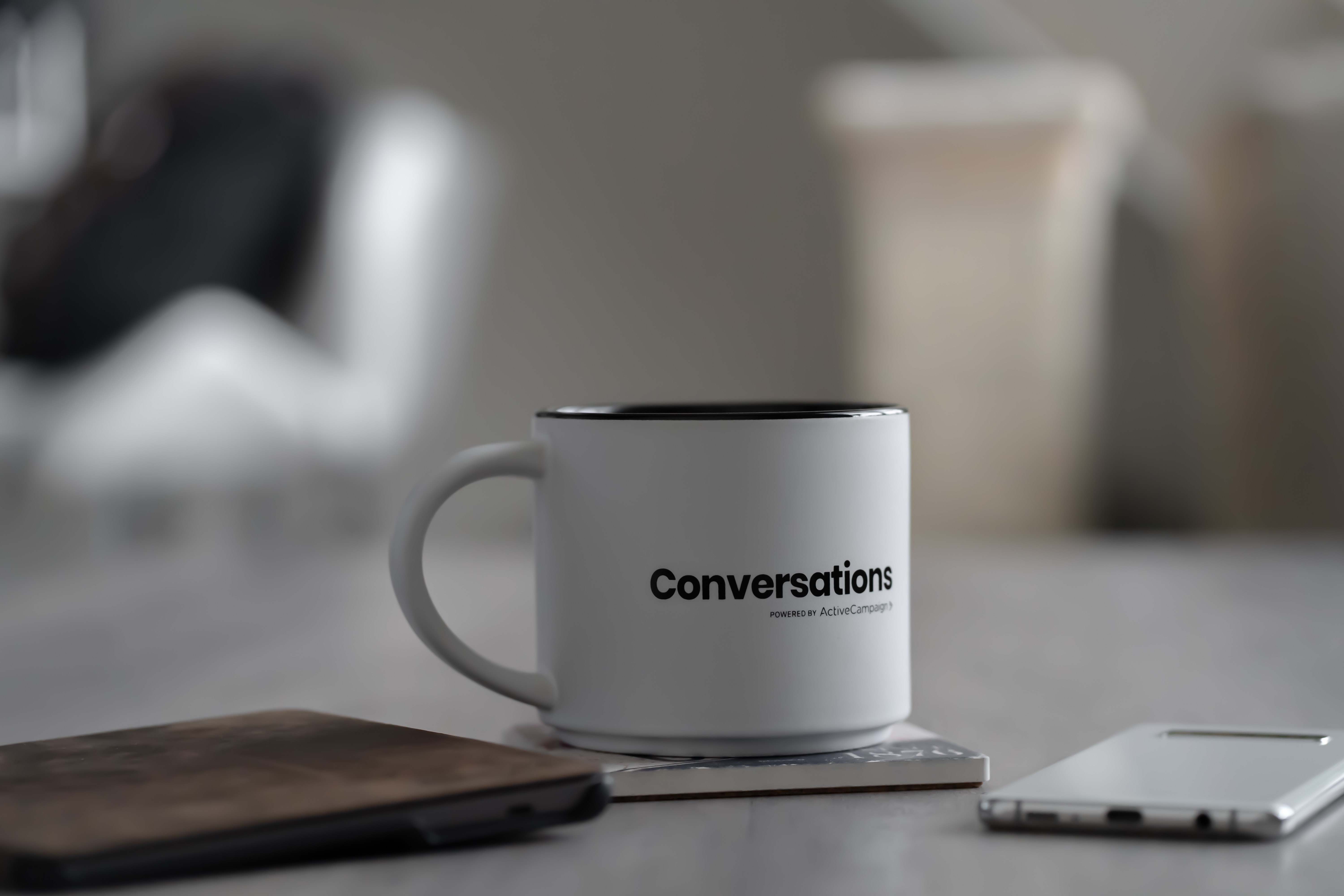 a white mug with the word 'conversations' printed