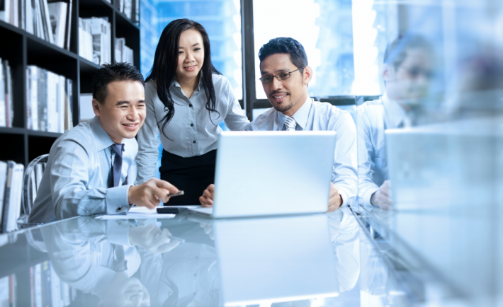 colleagues looking at a laptop