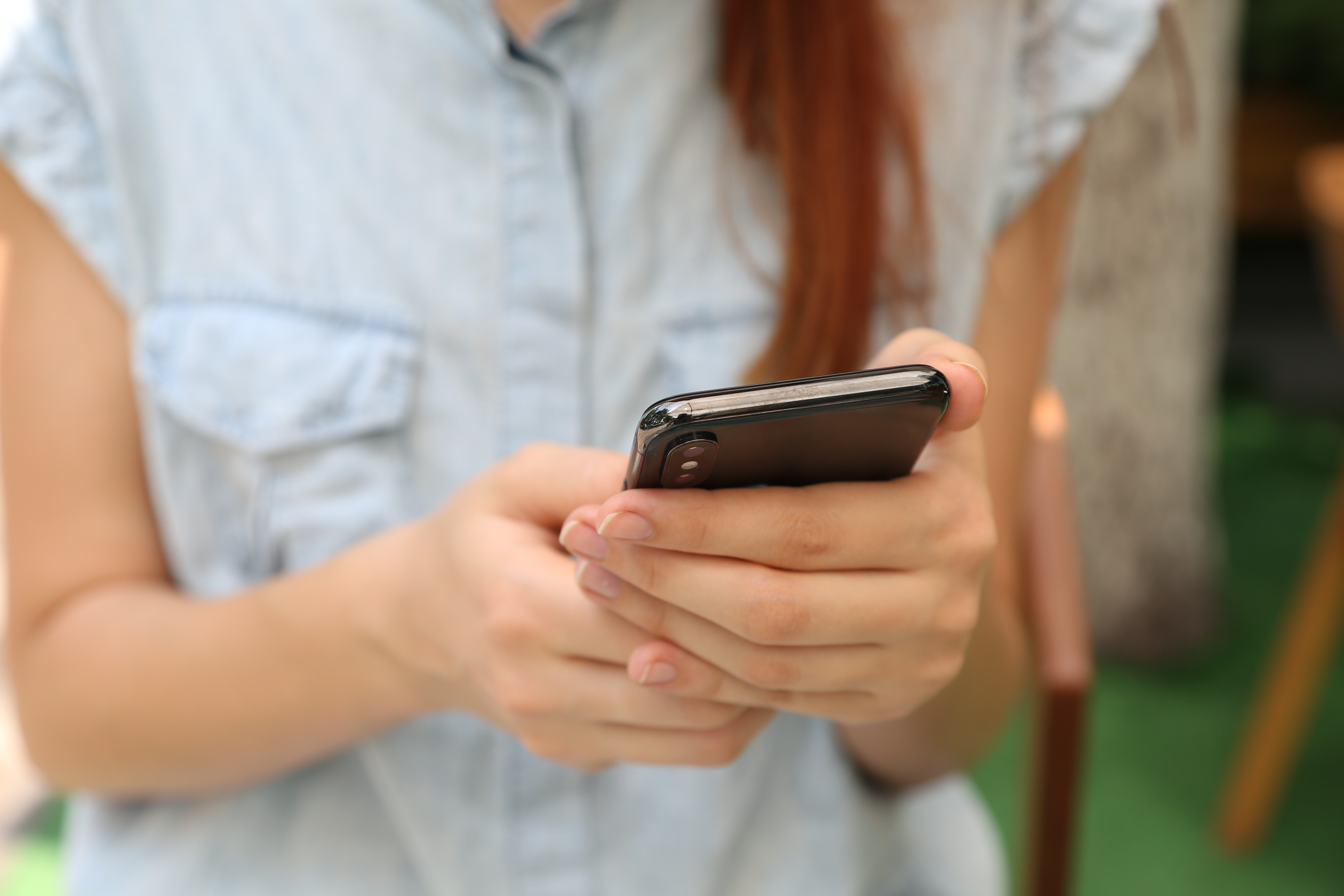 a woman holding onto an iPhone