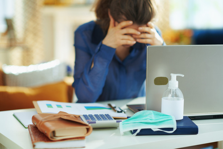 a stressed woman in front of her laptop