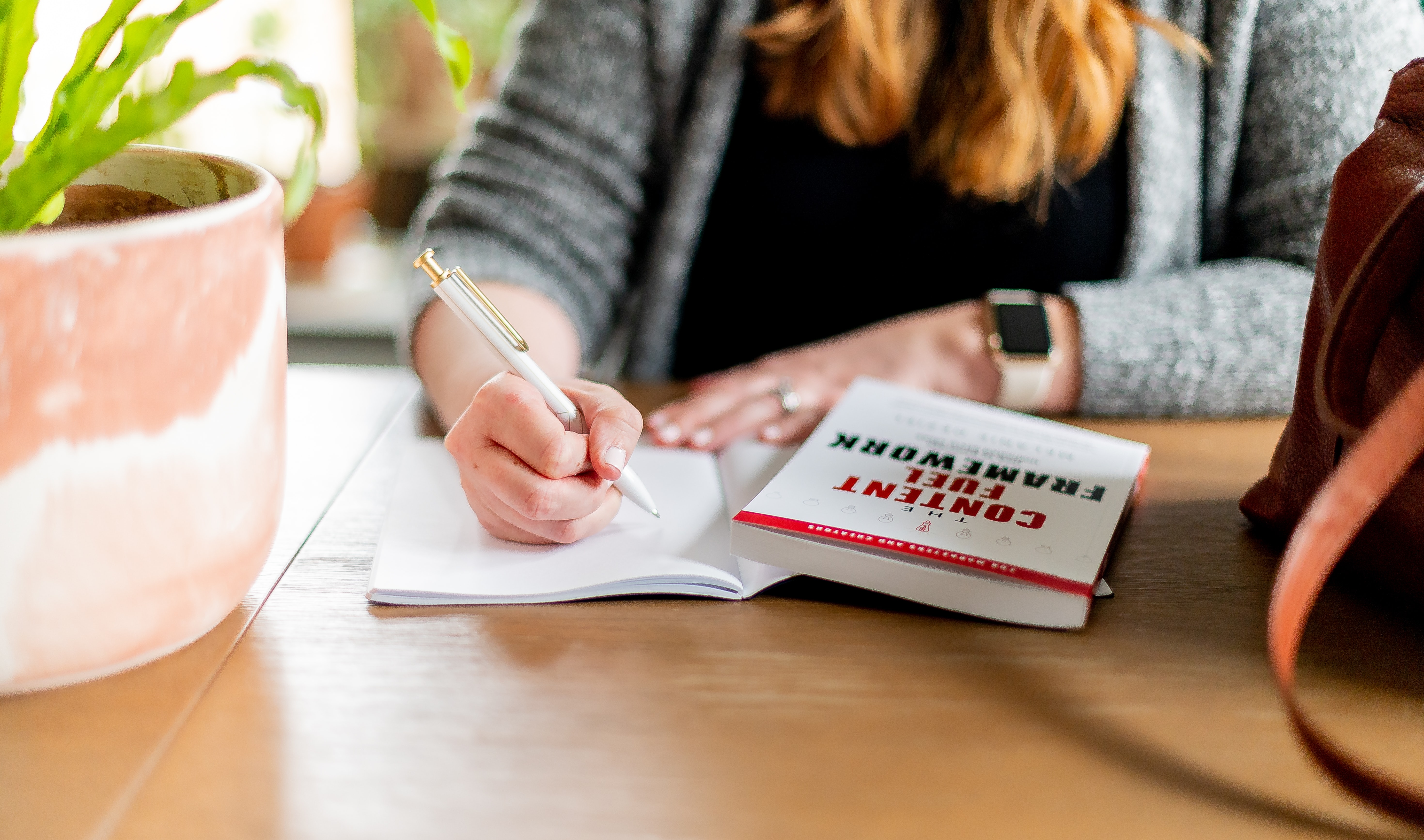 A woman taking notes on a book