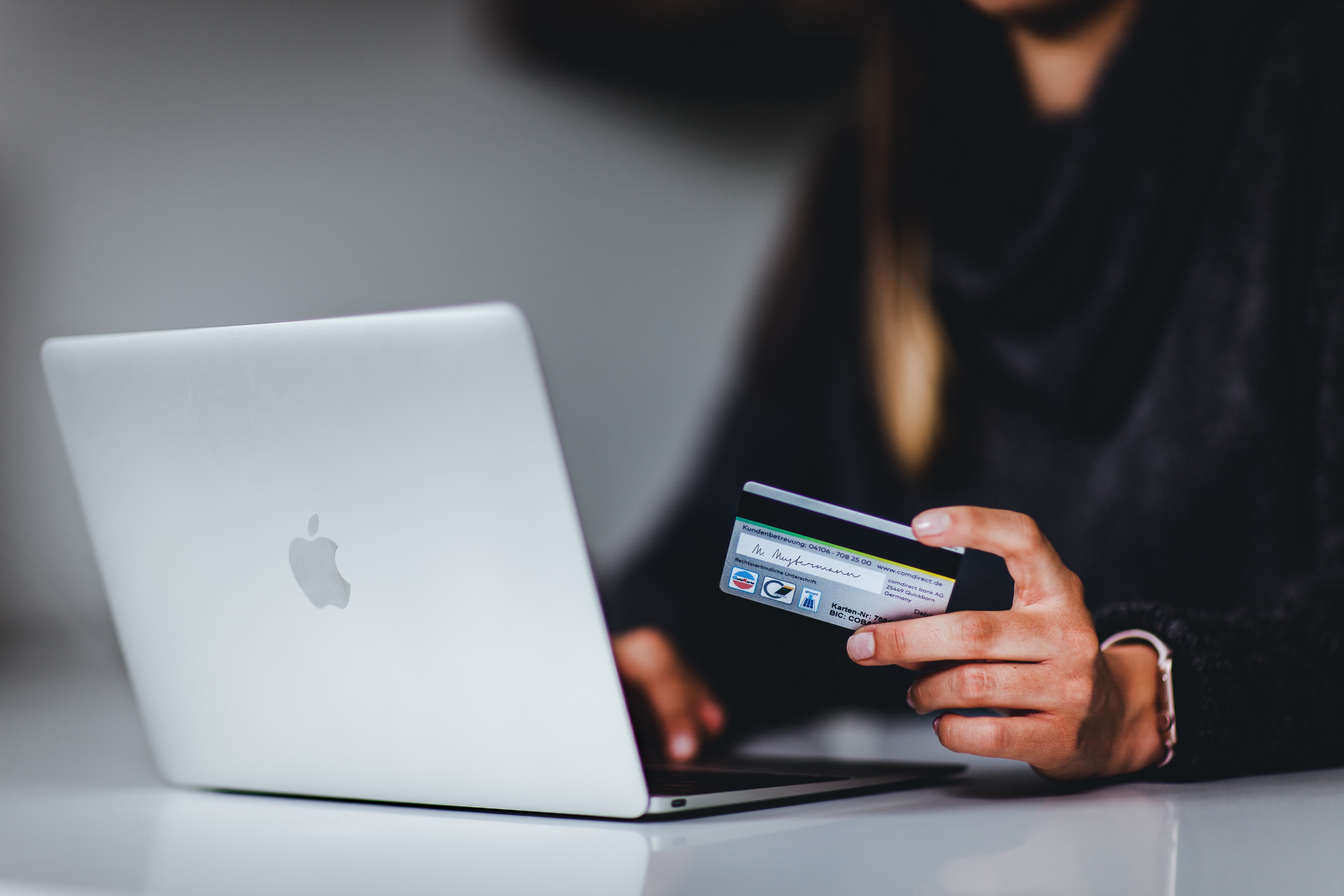 a woman holding onto a credit card