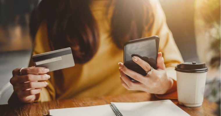 a woman keying her credit card details