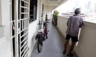 an elderly man looking out from the corridor