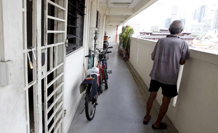 an elderly man looking out from the corridor