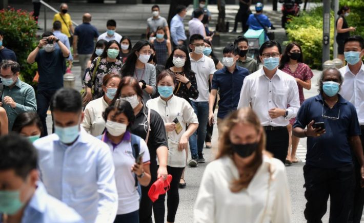 Singapore residents crossing the road