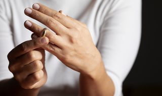 a woman removing her wedding ring