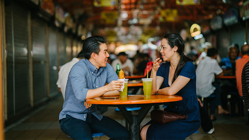 two persons talking at a hawker centre