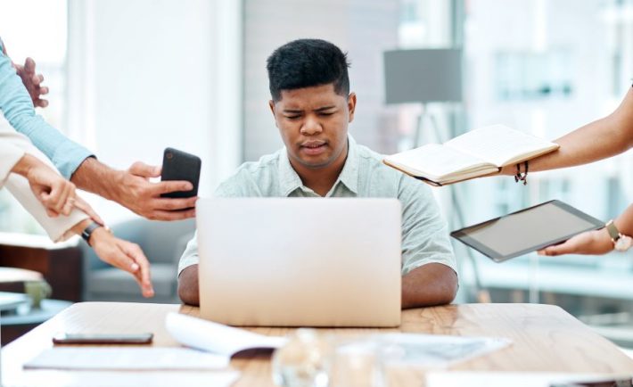 a man overloaded with work requests