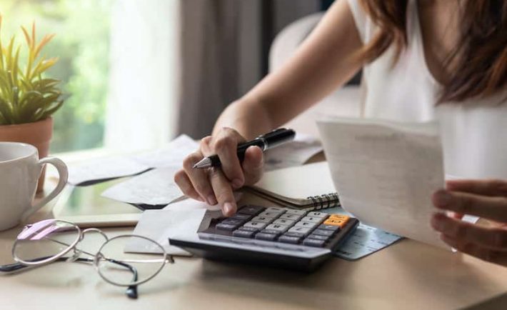 a woman calculating her expenses