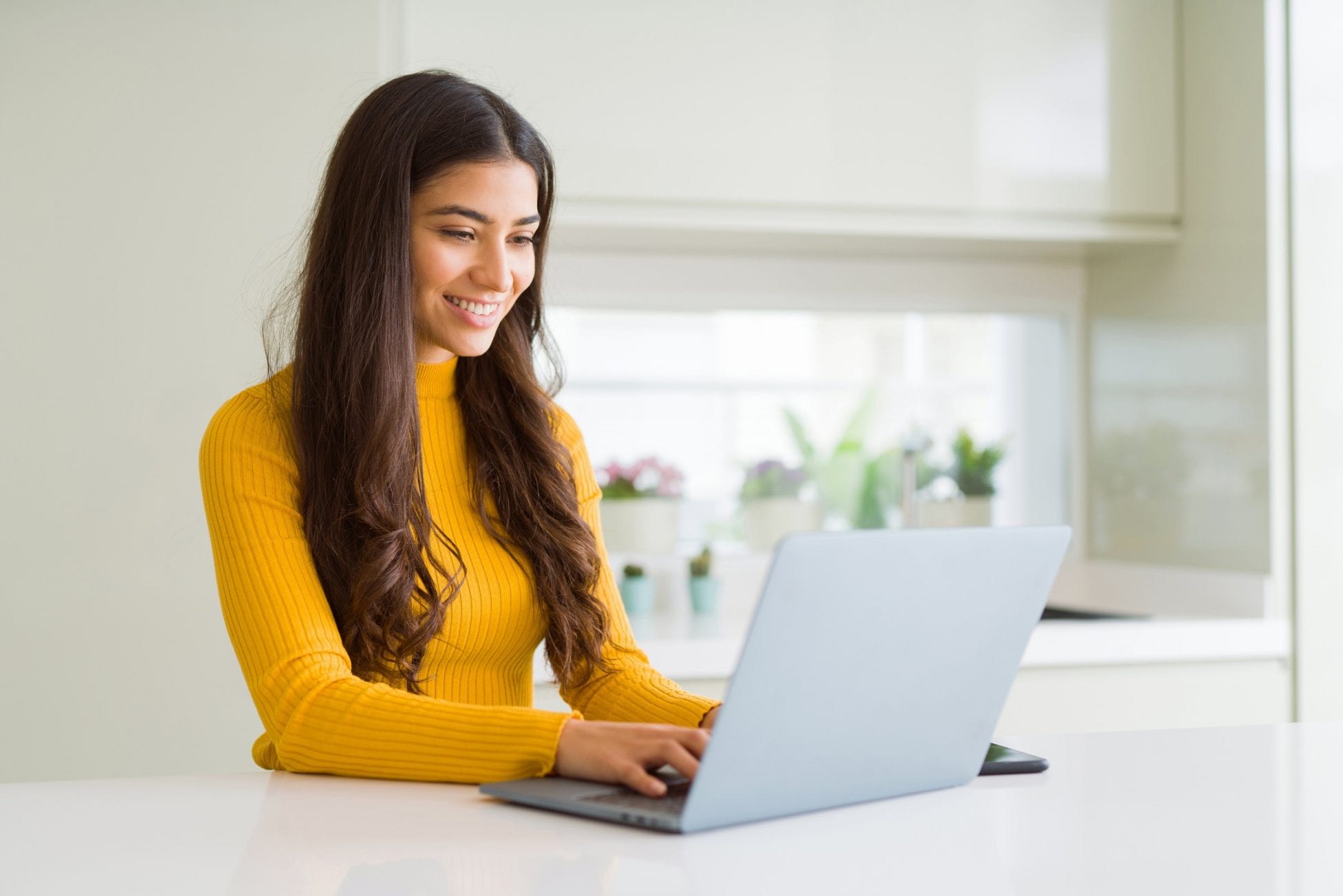 a young woman using her laptop