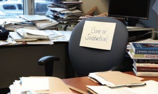 an empty chair in the office due to sabbatical leave