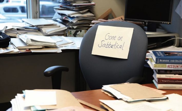 an empty chair in the office due to sabbatical leave