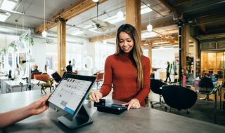 a woman swiping her credit card in-store