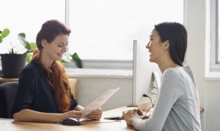 two ladies conversing and smiling