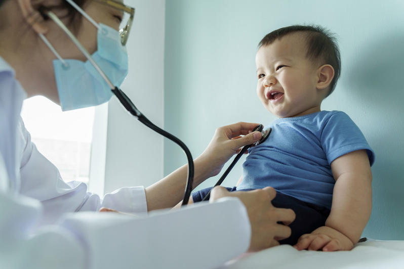 a pediatrician examining a baby