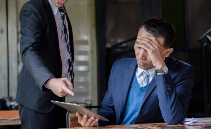 an angry boss criticizing his employee