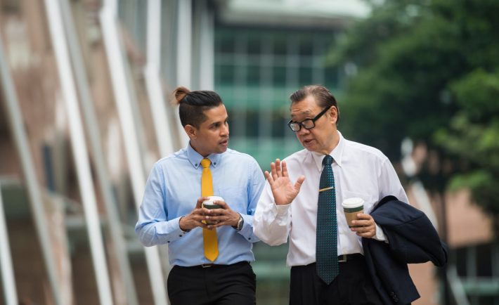 colleagues talking while walking